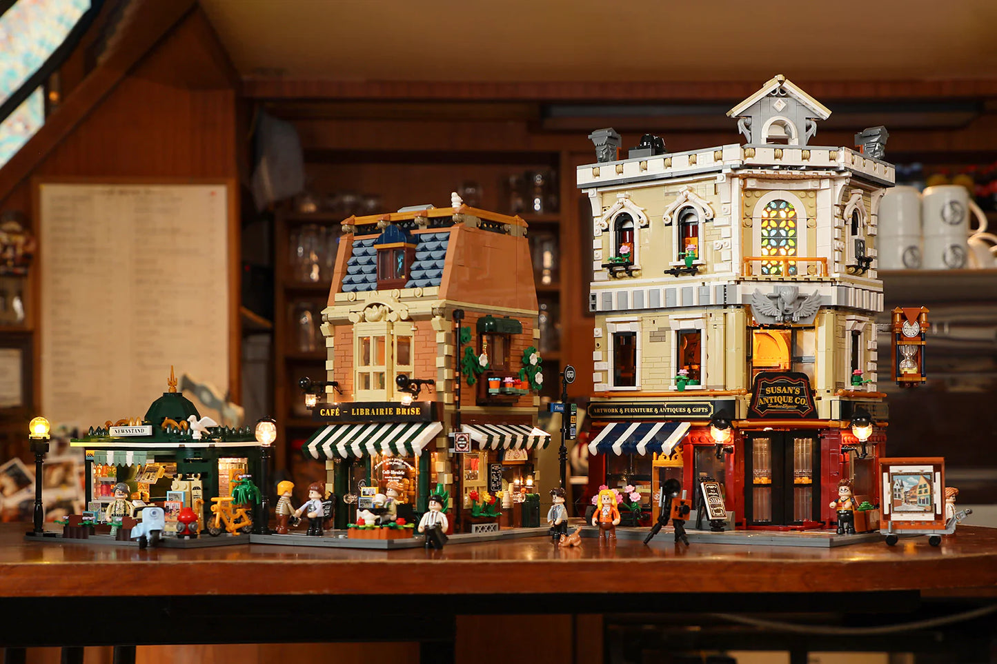 Funwhole Book Cafe displayed alongside an antique shop and newsstand, creating a charming modular building streetscape.