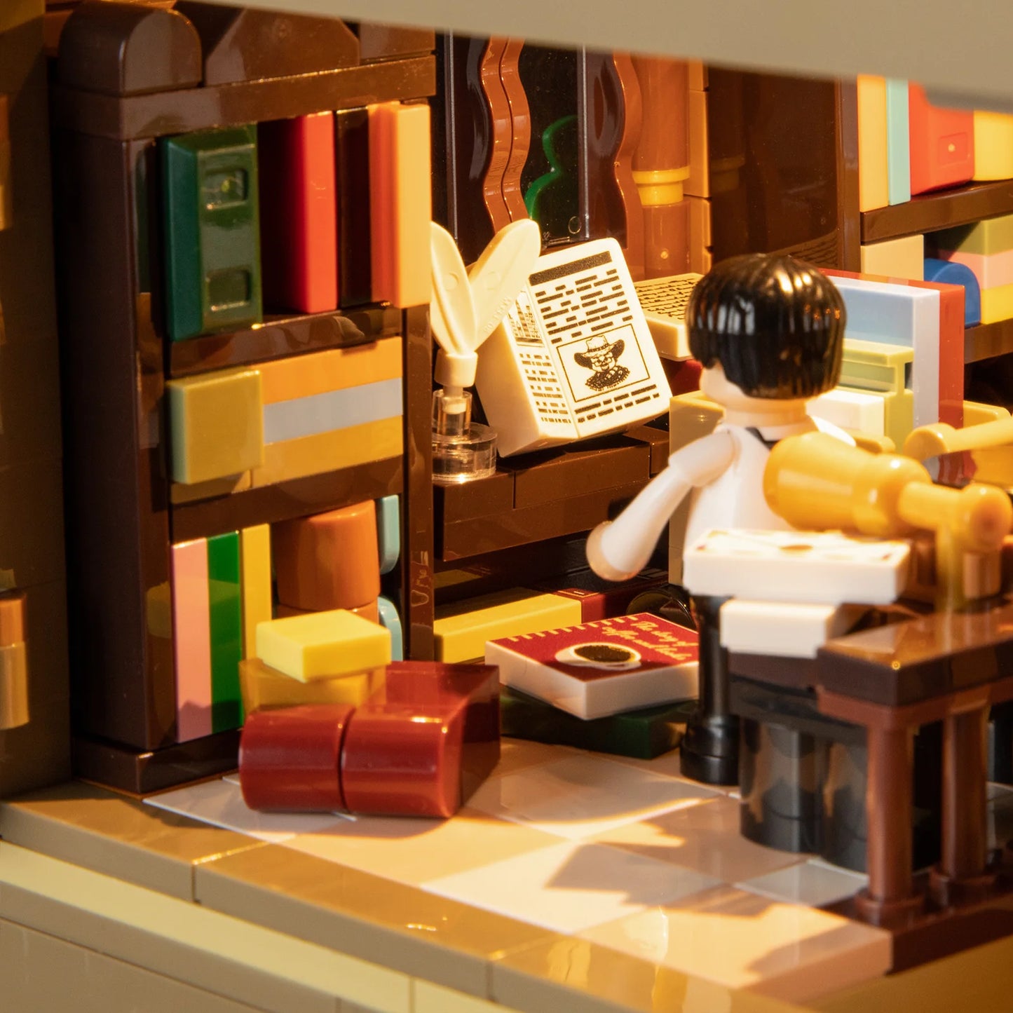 Funwhole Book Cafe interior featuring bookshelves, a desk, and a minifigure reading under warm lighting for a cozy ambiance.