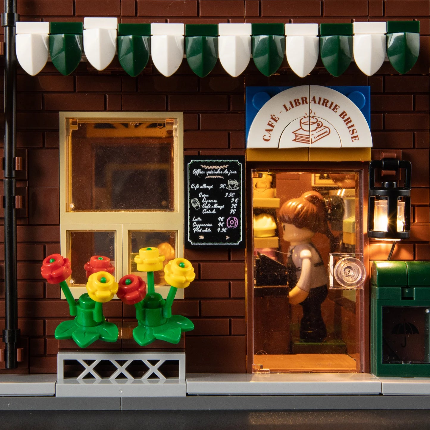 Funwhole Book Cafe entrance with a menu board, flower decorations, a lit lantern, and a mini-figure inside the cozy café.