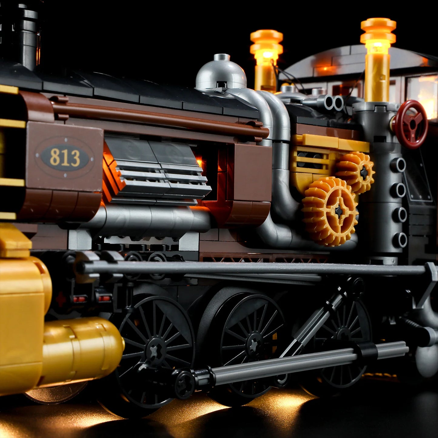Lumibricks F9006 Steampunk Ore Train engine side view with brass gears, pipes, wheels, and warm LED lighting