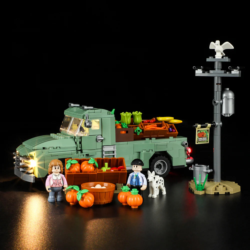 Lumibricks F9016 Farm Truck night display with green truck, minifigures, dog, pumpkins, eggs, and market stand