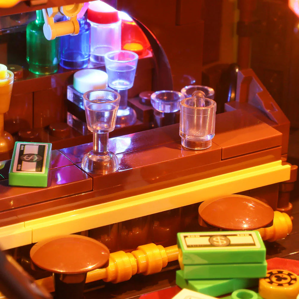 Lumibricks F9021 Western Saloon illuminated bar counter with glassware, colorful bottles, cash bricks, and rustic stools