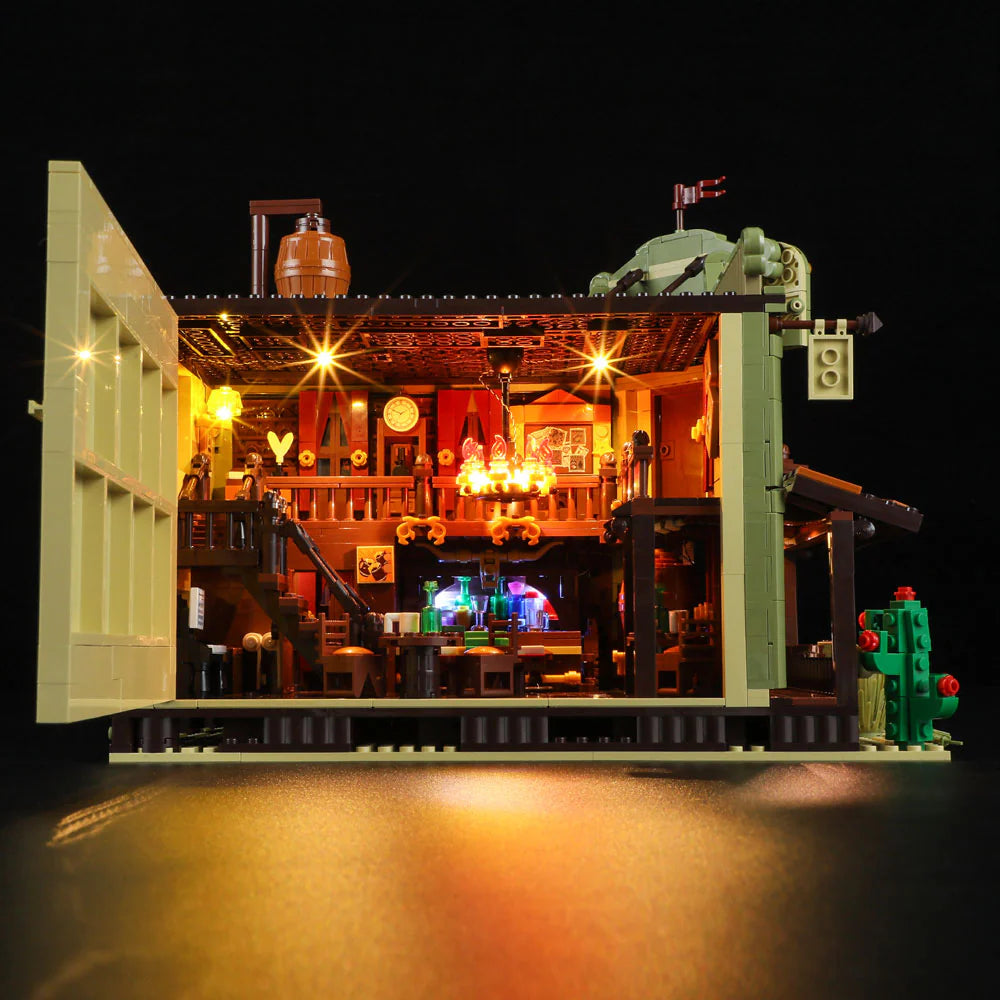 Lumibricks F9021 Western Saloon interior cutaway with glowing chandelier, balcony, bar counter, tables, and detailed rustic decor