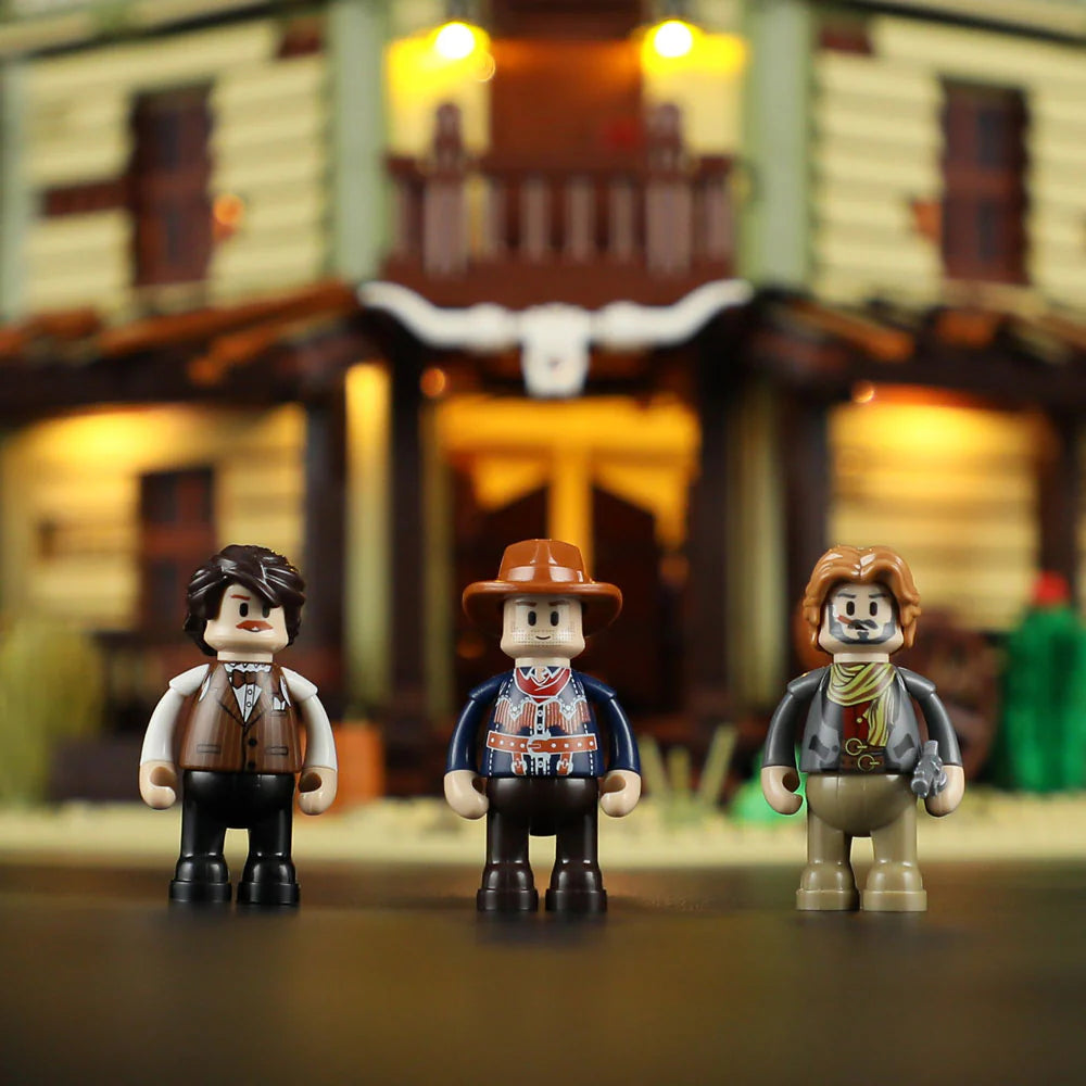 Lumibricks F9021 Western Saloon three cowboy minifigures in front of illuminated saloon porch with rustic Old West backdrop