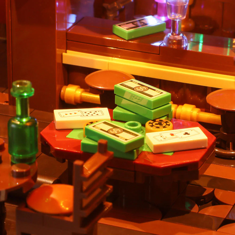 Lumibricks F9021 Western Saloon interior poker table scene with glowing lights, money bricks, playing cards, and glassware