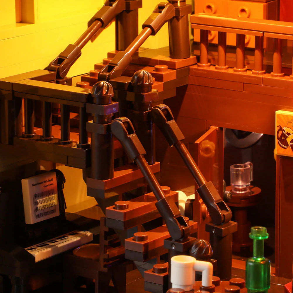 Lumibricks F9021 Western Saloon close-up of illuminated staircase, upright piano, and detailed saloon furnishings