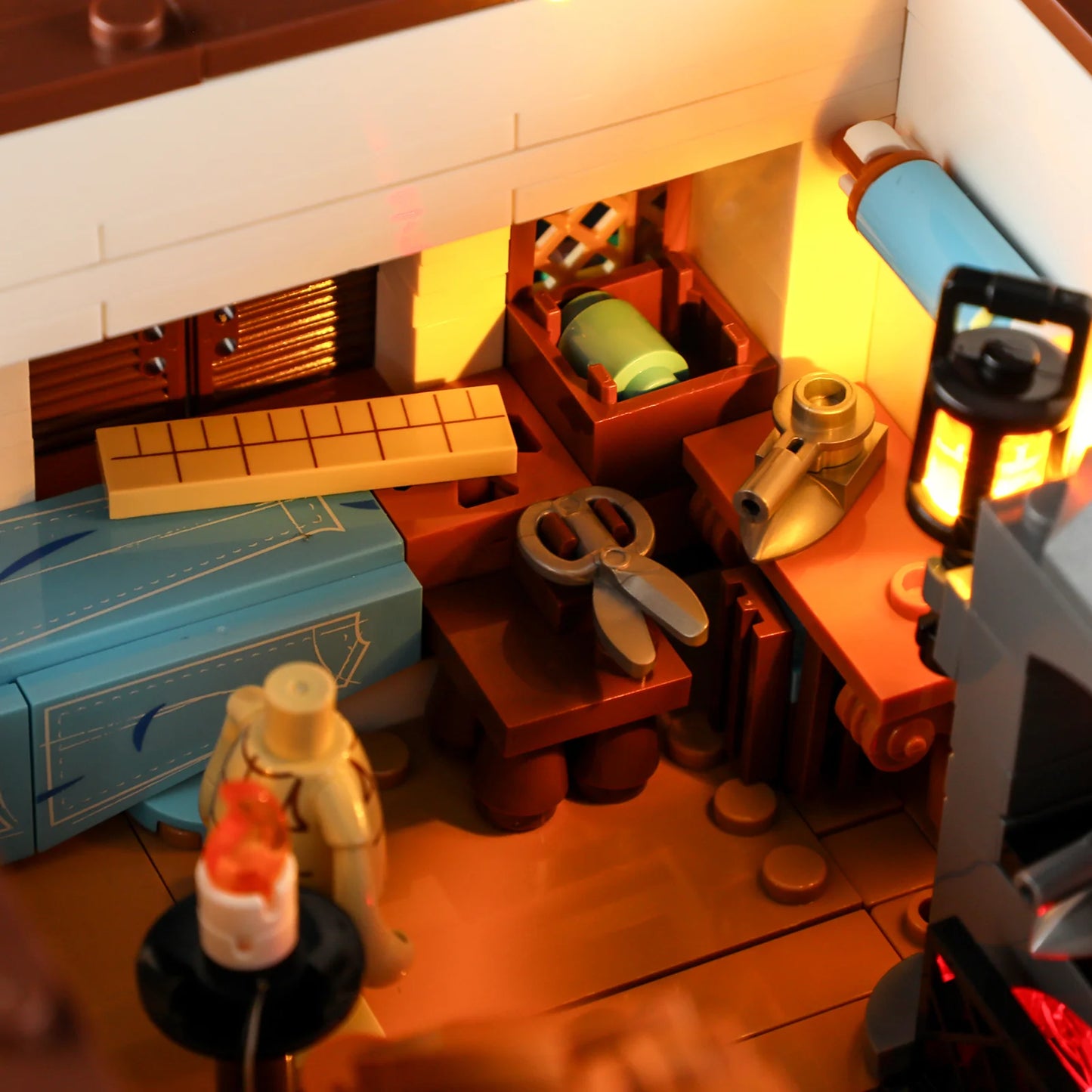 Lumibricks F9038 Medieval Tailor Shop workshop with sewing tools, fabric patterns, scissors, and glowing lantern