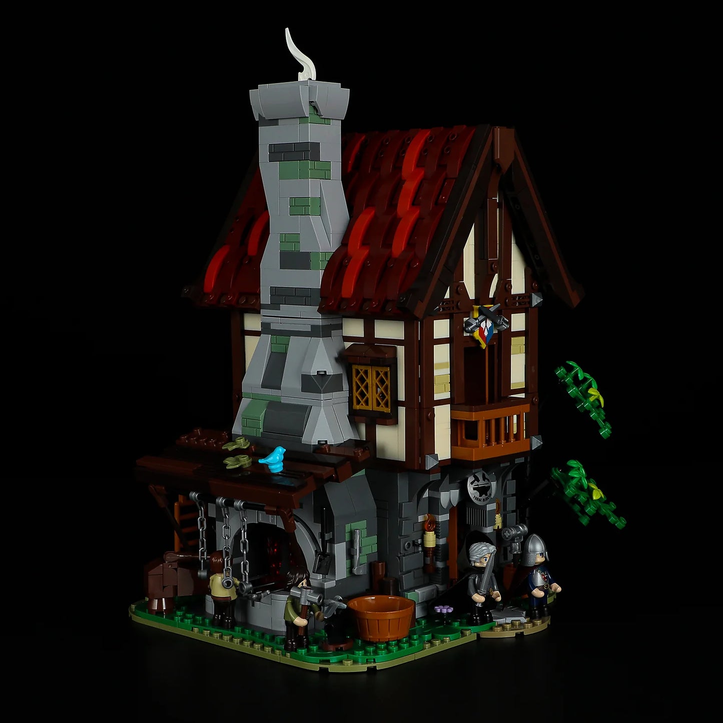 Lumibricks F9040 Forge House angled view with tall stone chimney, red roof, blacksmith forge, and minifigures in medieval setting