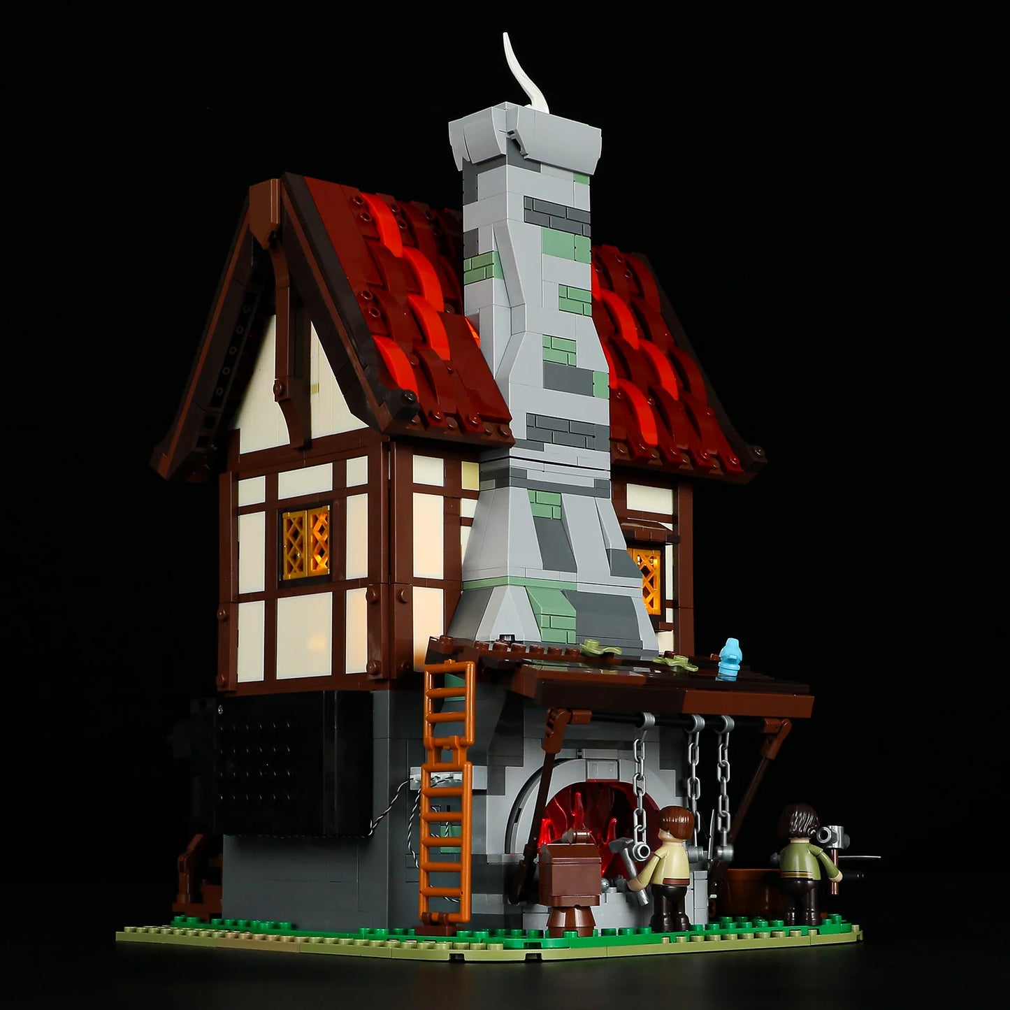 Lumibricks F9040 Forge House night view with tall stone chimney, glowing forge, and blacksmith minifigures at work