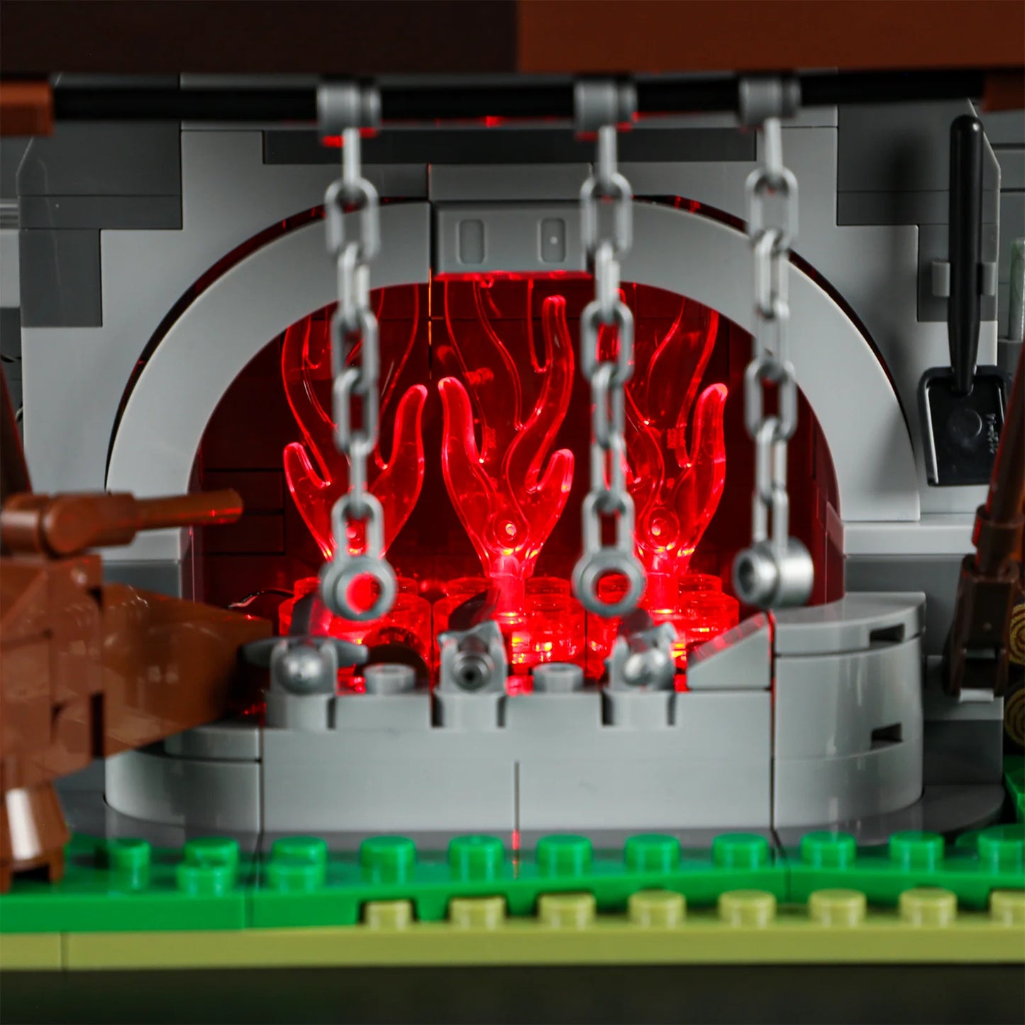 Lumibricks F9040 Forge House close-up of glowing red forge with hanging chains and medieval smithing tools