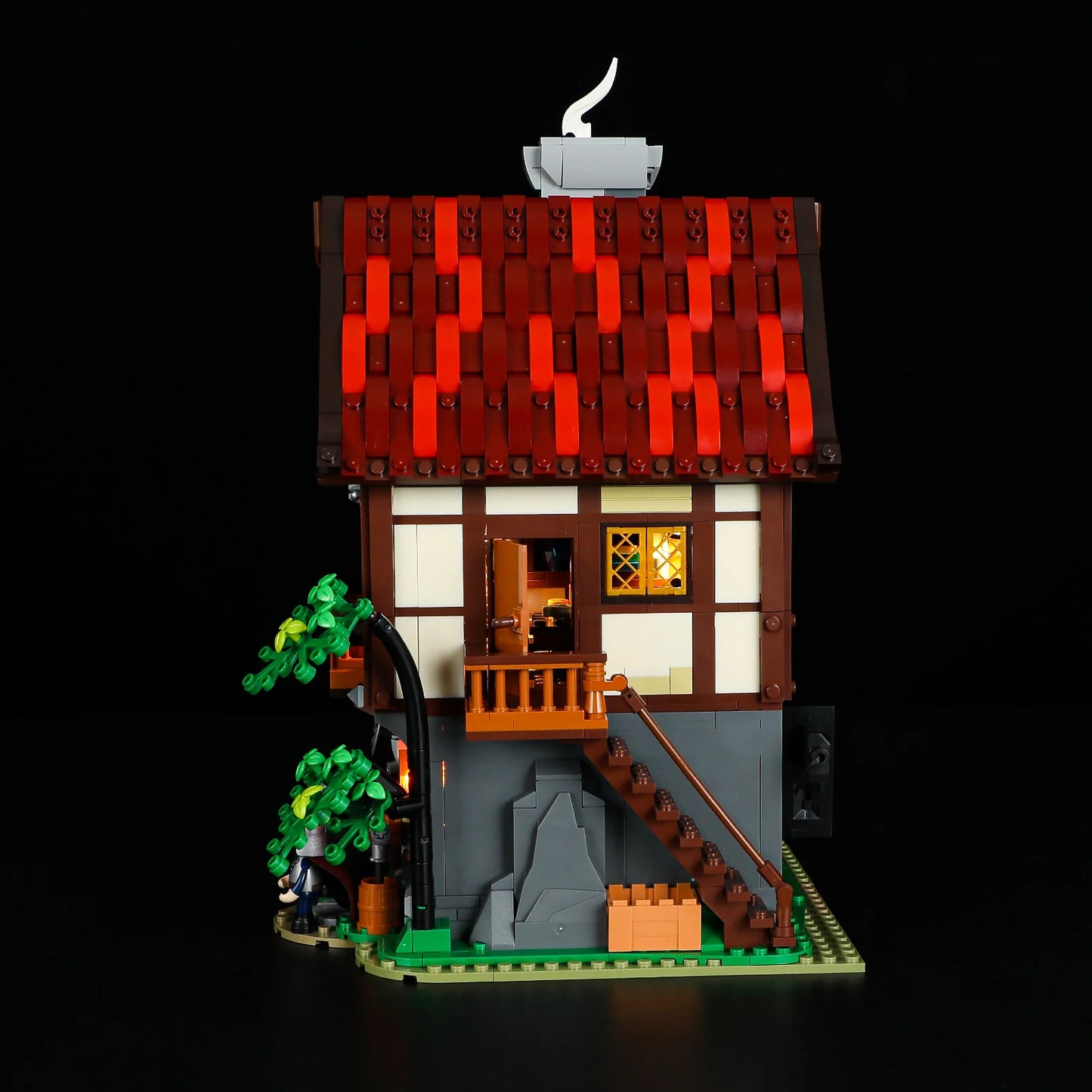 Lumibricks F9040 Forge House side view showing outdoor staircase, balcony, open window, and glowing interior lights