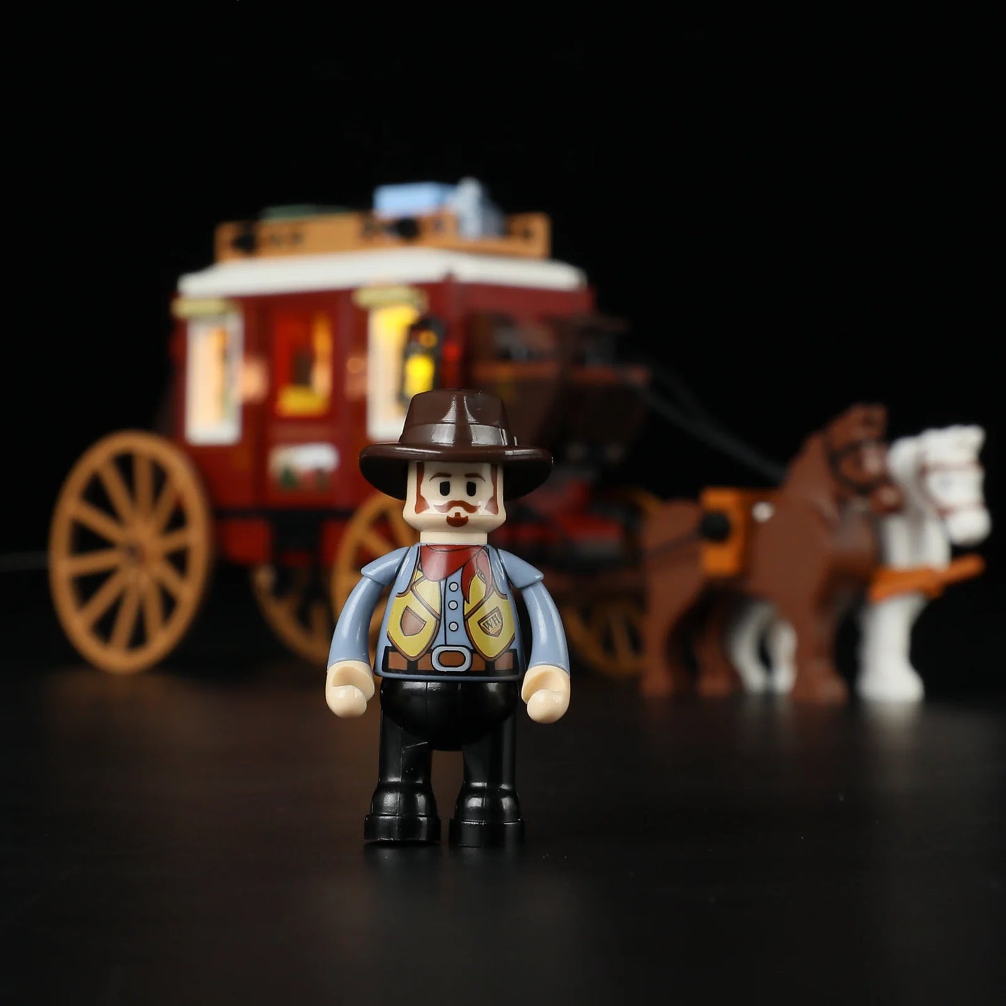 Lumibricks (Formerly Funwhole) F9052 Western Stagecoach front view with brown and white horses, illuminated coach windows, and cowboy driver
