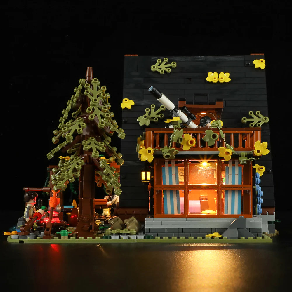 Funwhole A-Frame Cabin LEGO set night view featuring a stargazing telescope, glowing cabin windows, tree, and detailed scenery