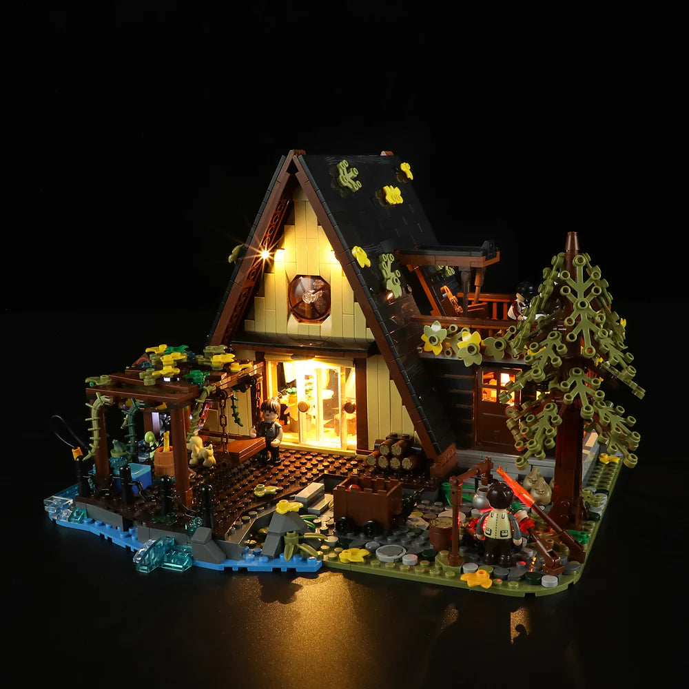 Funwhole A-Frame Cabin LEGO set illuminated at night with cozy lighting, detailed outdoor scene, and minifigures