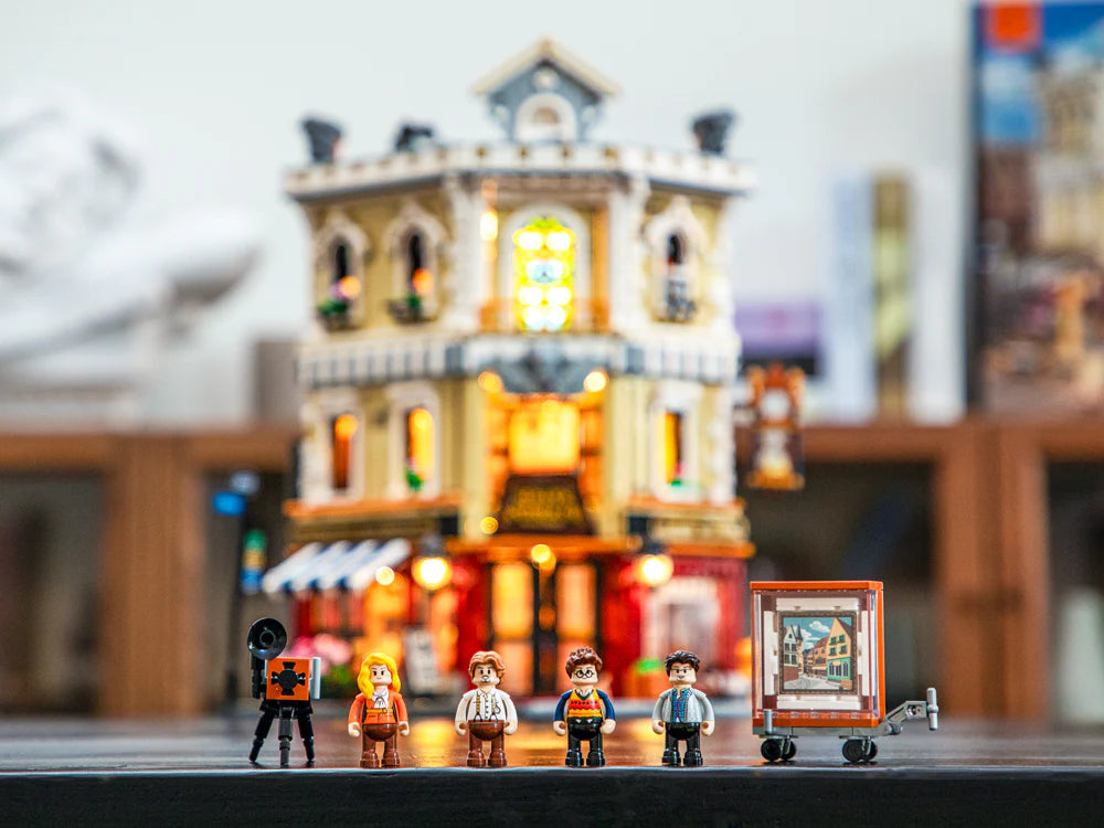 Funwhole Antique Store set with detailed minifigures, accessories, and a trolley featuring an artwork piece in front of the illuminated store.