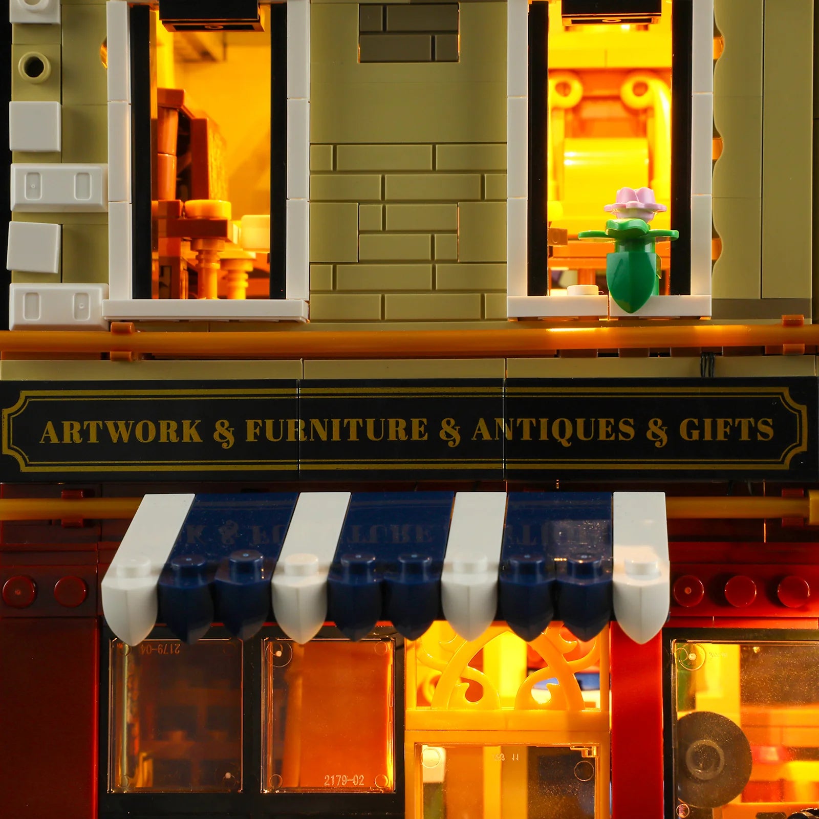 Close-up of Funwhole Antique Store signage with "Artwork & Furniture & Antiques & Gifts" text, blue awning, and warm lighting.