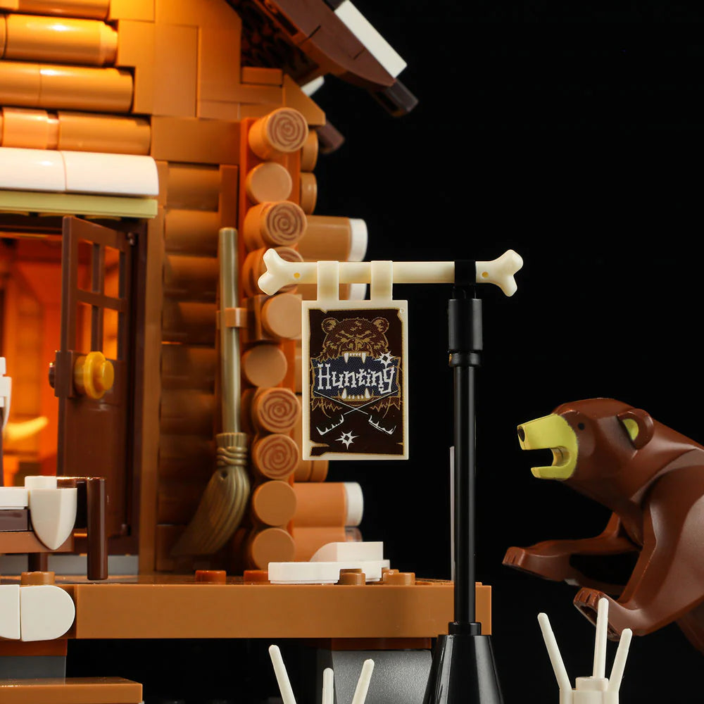Funwhole Hunting Cabin set featuring a detailed hunting sign, rustic log walls, and a bear figure near the entrance