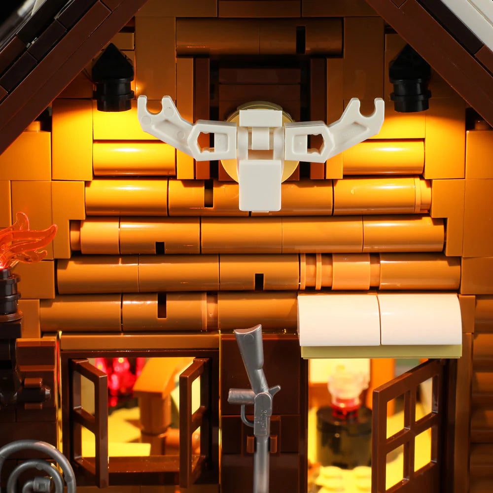 Close-up of Funwhole Hunting Cabin set with mounted deer antlers and warm cabin lighting, creating a rustic lodge atmosphere