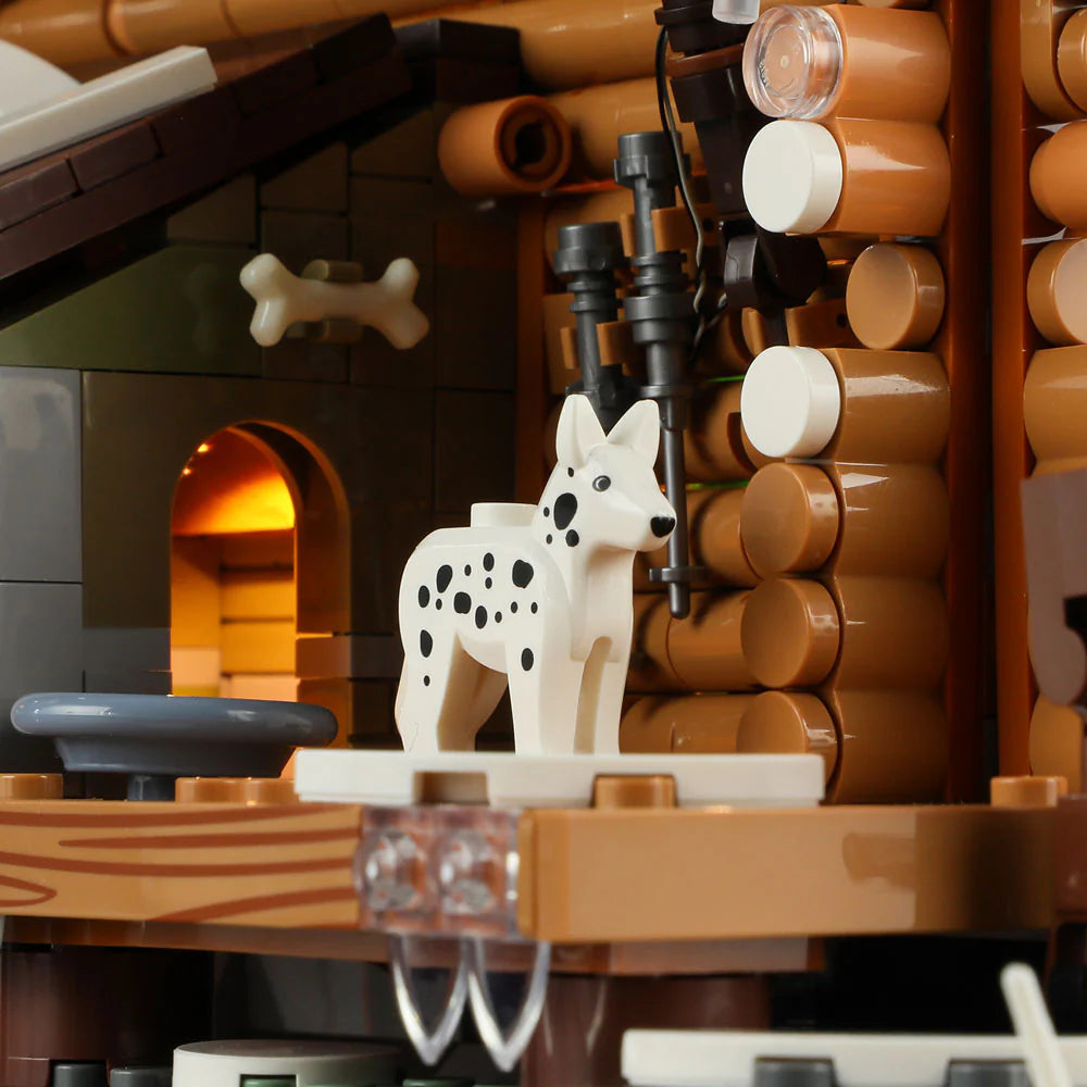 Funwhole Hunting Cabin set featuring a detailed dog figure on the wooden porch with a cozy lit interior in the background