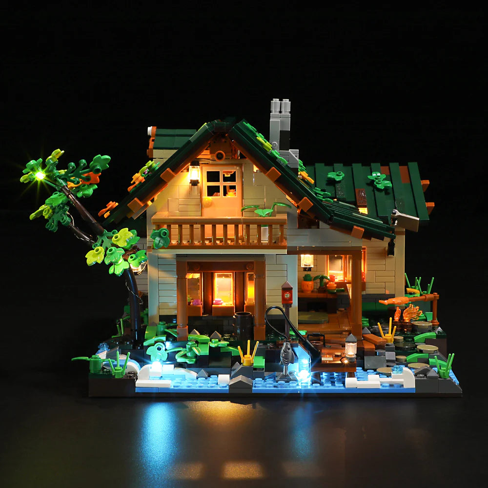 Front view of Funwhole Lakeside Lodge set at night, featuring warm interior lights and glowing outdoor scenery