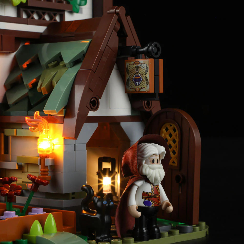 Funwhole Medieval Apothecary Shop – Wizard minifigure at the entrance with glowing lanterns and a magical black cat companion