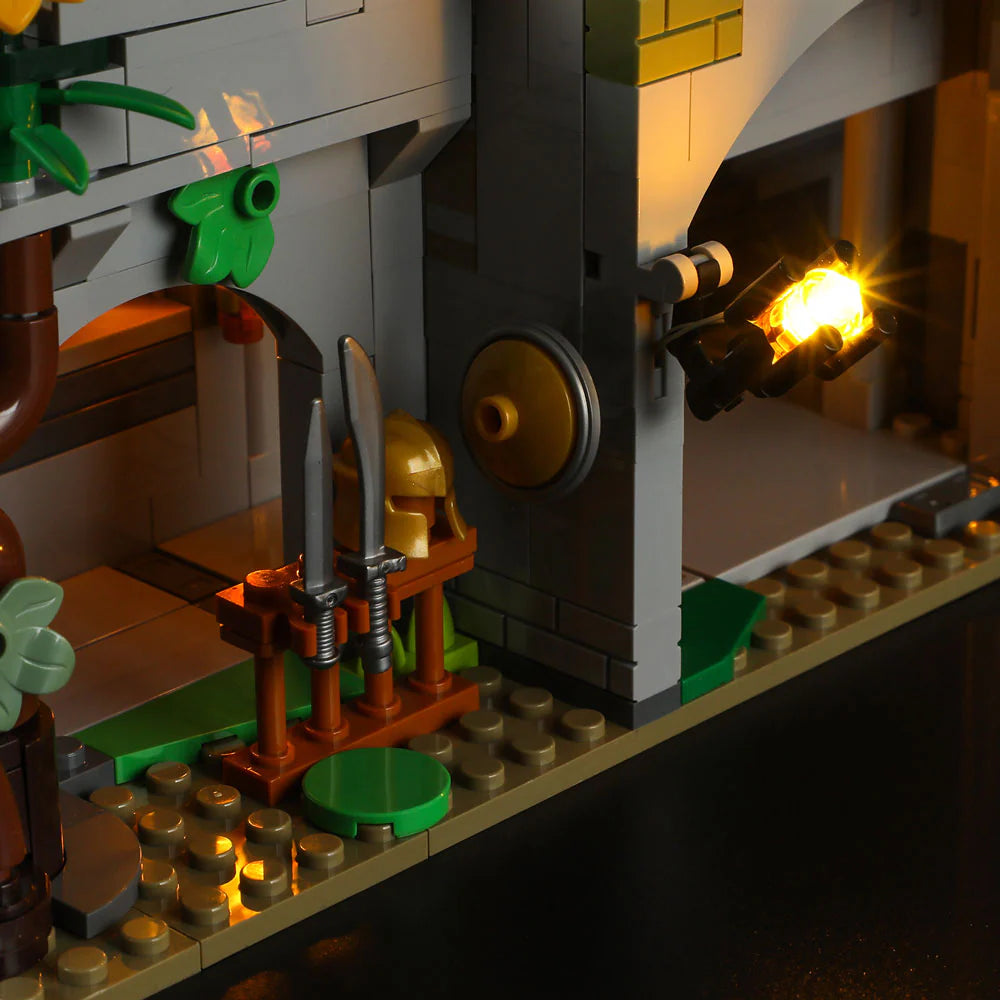 Funwhole Medieval Watchtower Set F9027 – Weapon rack with swords, helmet, and shield beside a glowing torch in the castle courtyard