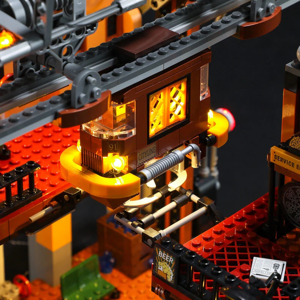Lumibricks F9007 Steampunk Train Station angled view with brass gears, pipes, and bright LED lighting effects