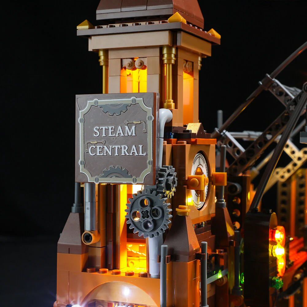 Lumibricks F9007 Steampunk Train Station "Steam Central" sign, clock tower, gears, and warm LED lighting at night