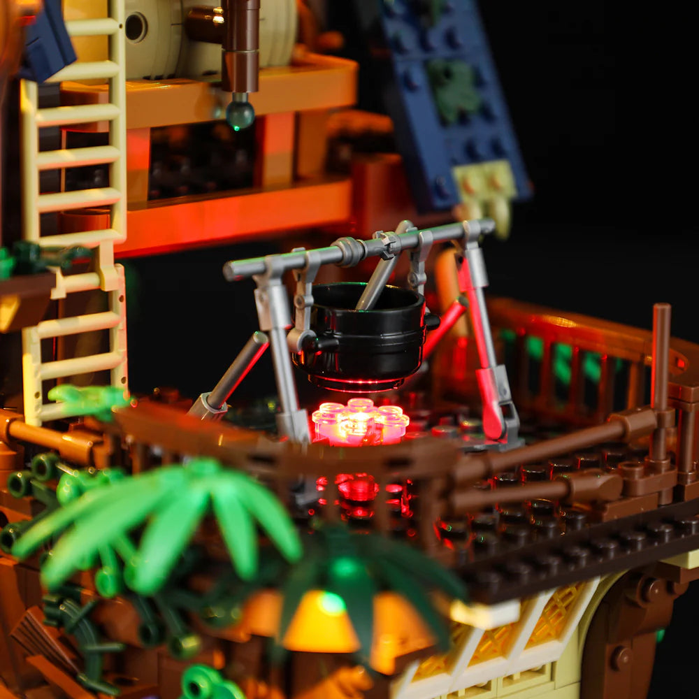 Lumibricks F9011 Medieval Pier Inn outdoor campfire scene with black cooking pot and red LED glow
