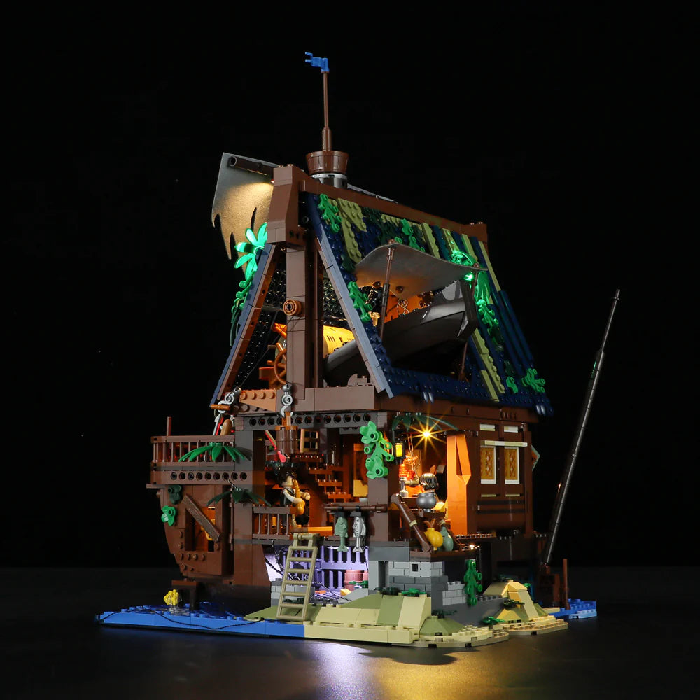 Lumibricks F9011 Medieval Pier Inn side view at night with balcony, boat on roof, minifigures, and glowing lights