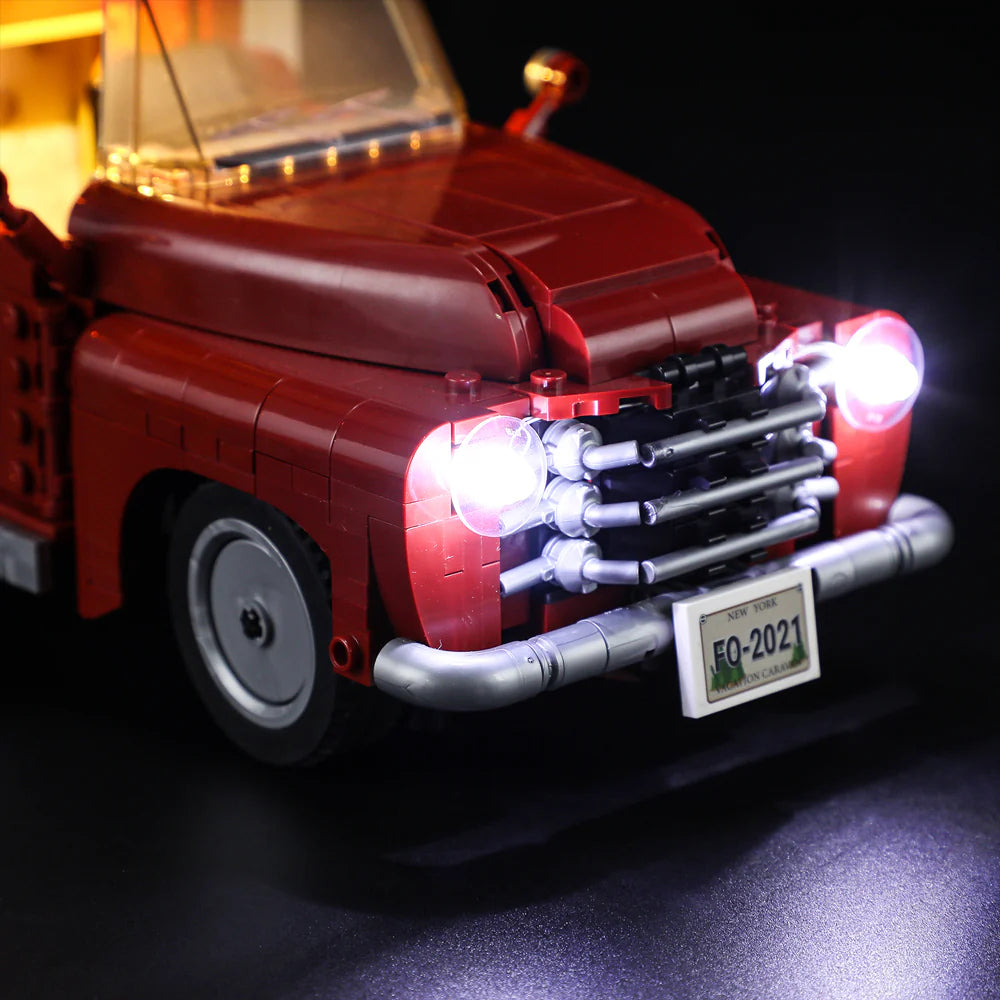 Lumibricks F9012 Camper Van close-up of red front grill, bright LED headlights, and New York license plate