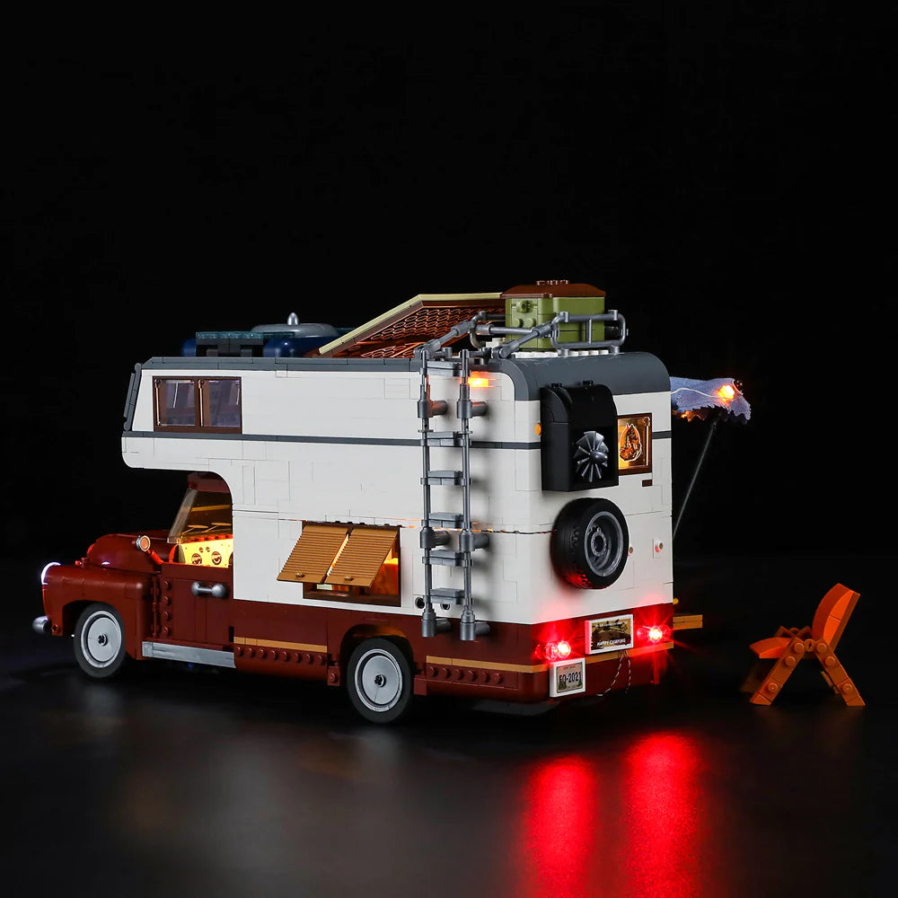 Lumibricks F9012 Camper Van rear view with LED taillights, rooftop cargo, extended awning, and camp chair