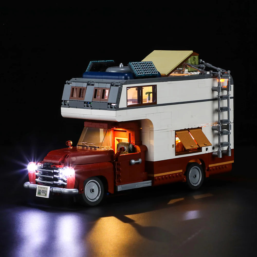 Lumibricks F9012 Camper Van side view at night with LED lights, roof panels, ladder, and open window shade