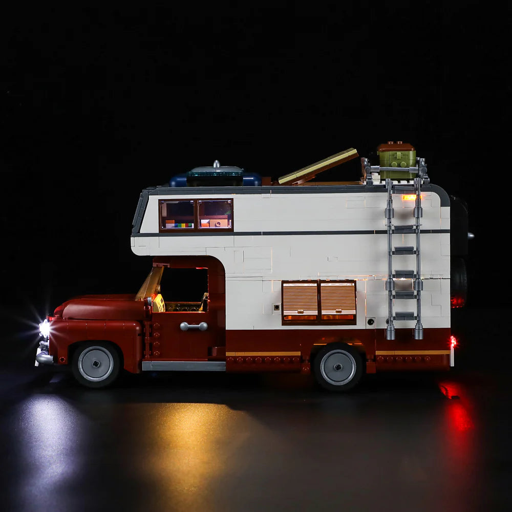 Lumibricks F9012 Camper Van side view with LED headlights, roof ladder, rooftop cargo, and illuminated windows