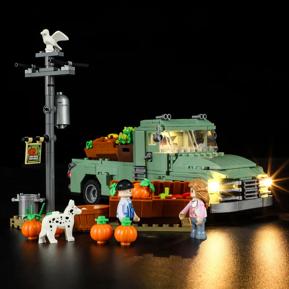 Lumibricks F9016 Farm Truck night scene with lit headlights, market stand, minifigures, pumpkins, and farm produce