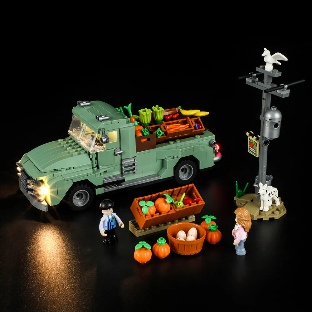 Lumibricks F9016 Farm Truck at night with LED headlights, market stand, minifigures, dog, pumpkins, and basket of eggs