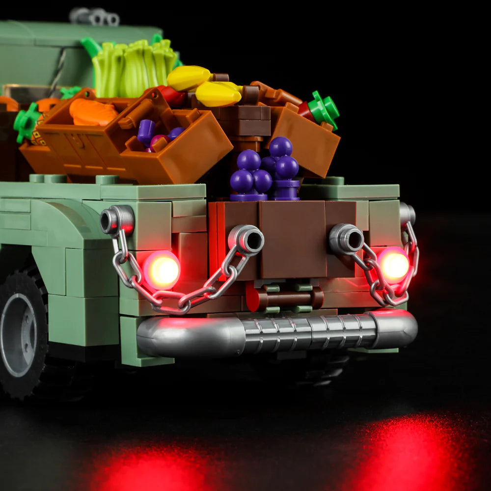 Lumibricks F9016 Farm Truck rear view with red LED taillights, chains, and loaded vegetable crates