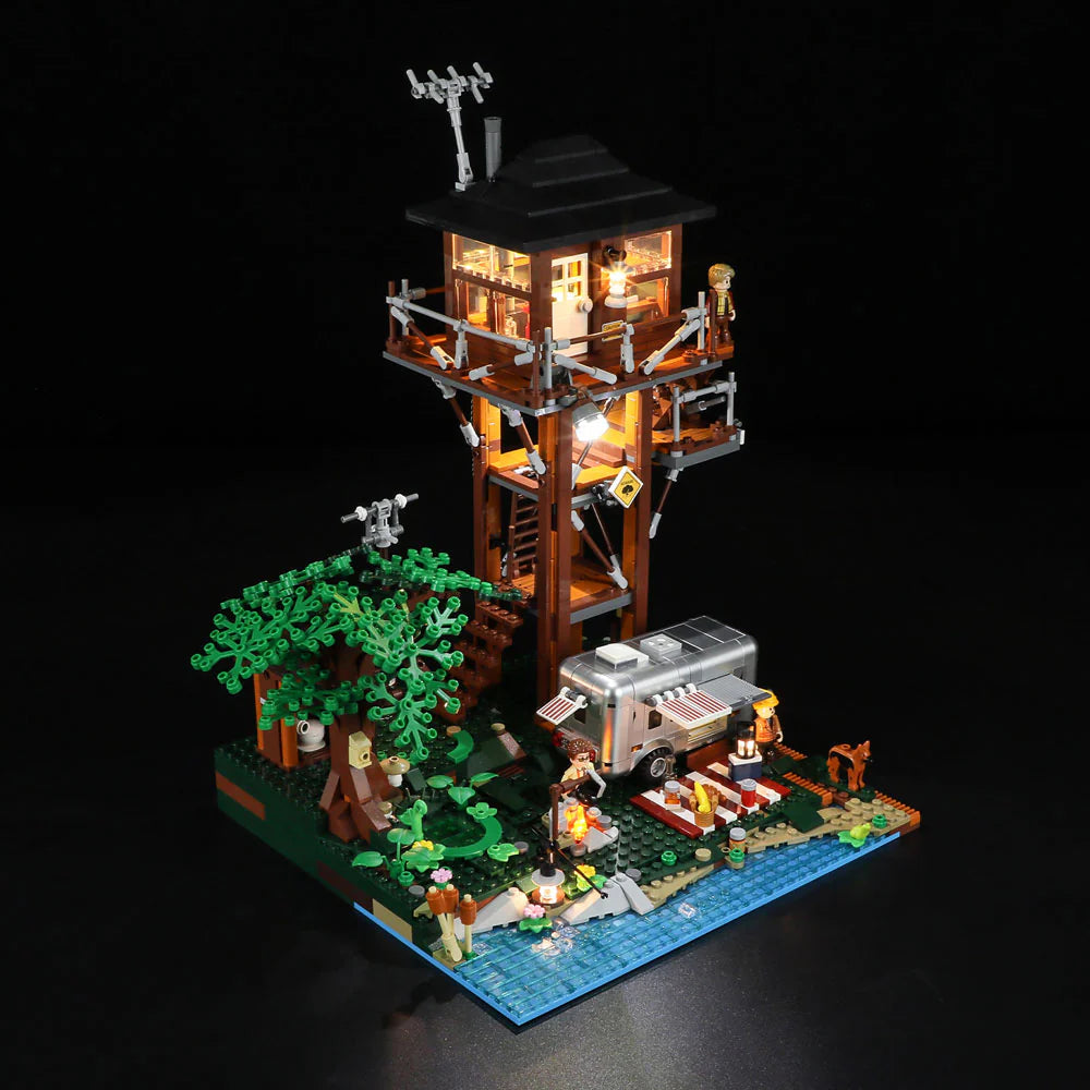 Lumibricks F9022 Lookout Campground with lit lookout tower, campfire, camper trailer, minifigures, trees, and water