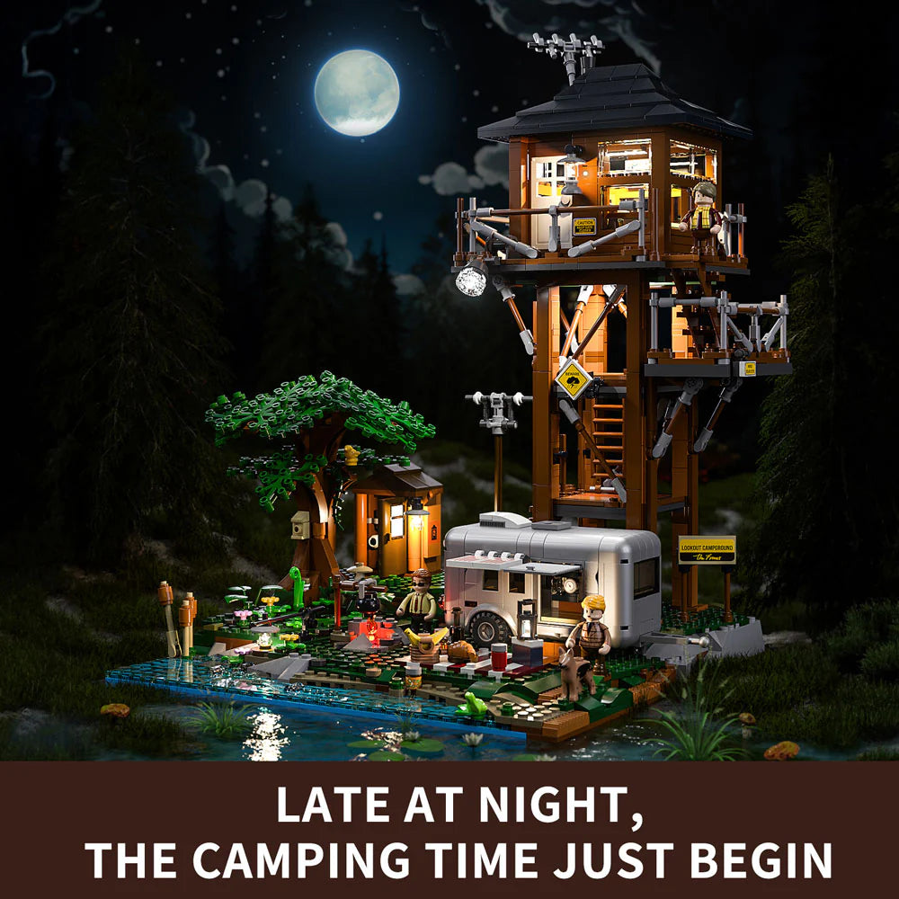 Lumibricks F9022 Lookout Campground at night with illuminated lookout tower, camper trailer, and moonlit sky