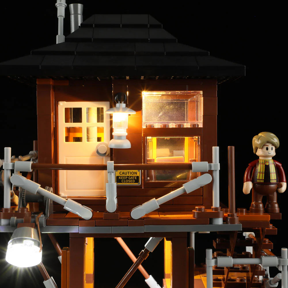 Lumibricks F9022 Lookout Campground illuminated lookout tower at night with minifigure on balcony and glowing lantern