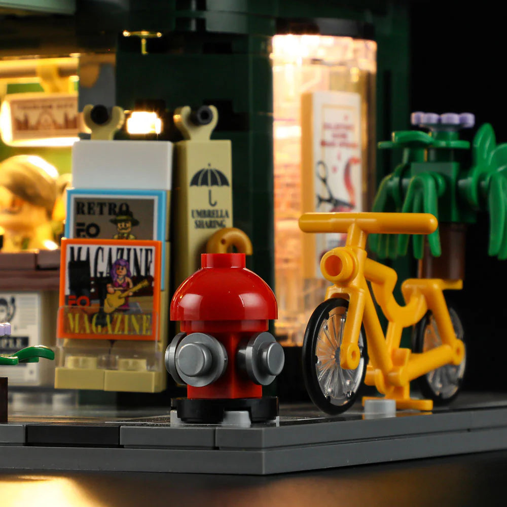 Lumibricks F9023 Newsstand sidewalk scene with yellow bicycle, red fire hydrant, retro magazine rack, and illuminated shop