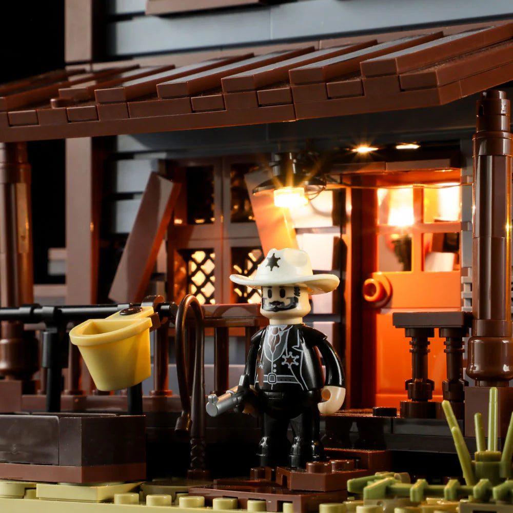 Lumibricks F9026 Sheriff’s Office porch at night with sheriff minifigure, illuminated lights, and yellow hat on railing