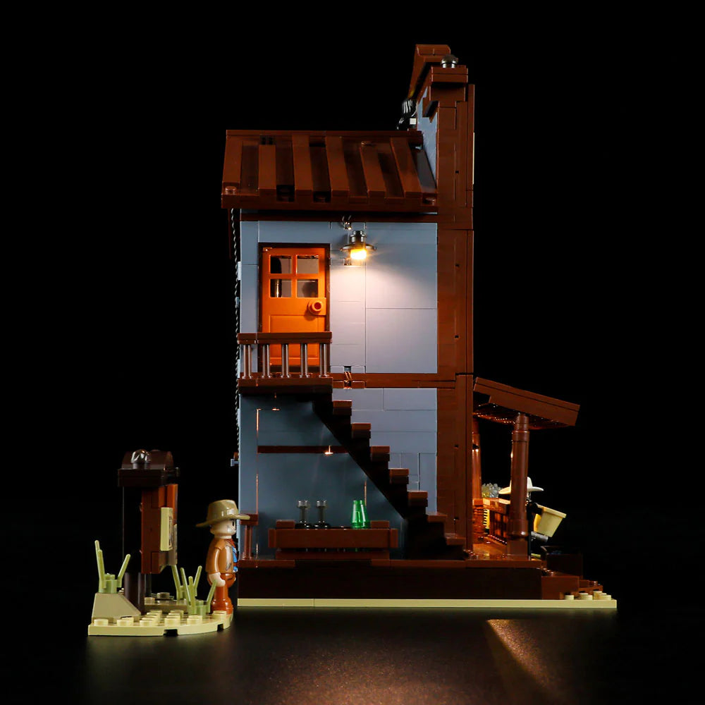 Lumibricks F9026 Sheriff’s Office side view at night with illuminated staircase, balcony door, and Western minifigure outside