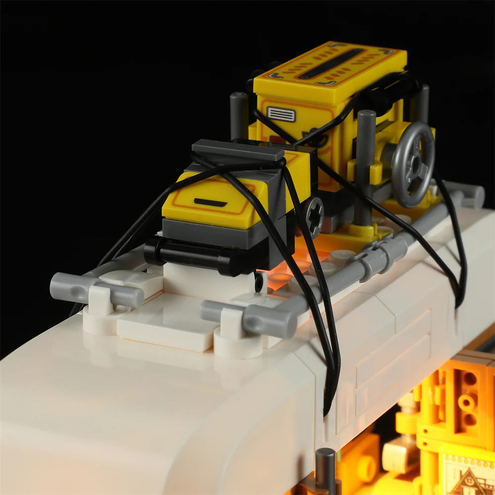 Lumibricks F9030 Carpentry Van rooftop with yellow woodworking tools, spare wheel, and black straps securing equipment