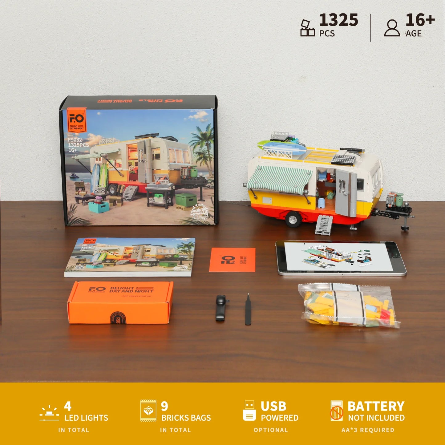 Lumibricks F9032 Travel Trailer package contents with assembled trailer, box, 9 brick bags, LED light kit, instructions, and USB power option