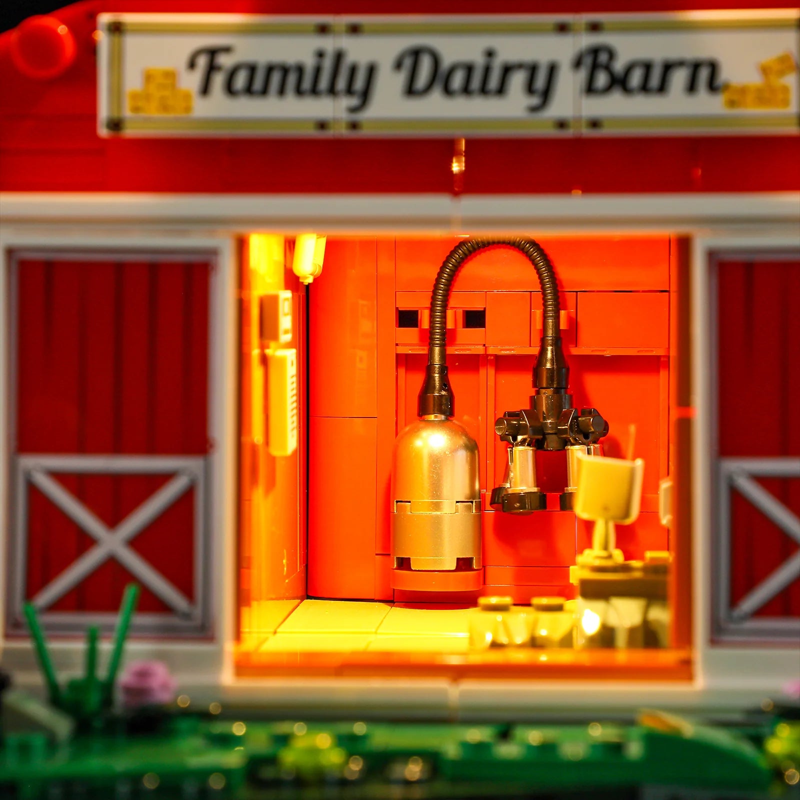 Lumibricks F9037 Cow Barn close-up of illuminated milking machine and equipment inside barn, with "Family Dairy Barn" sign abov