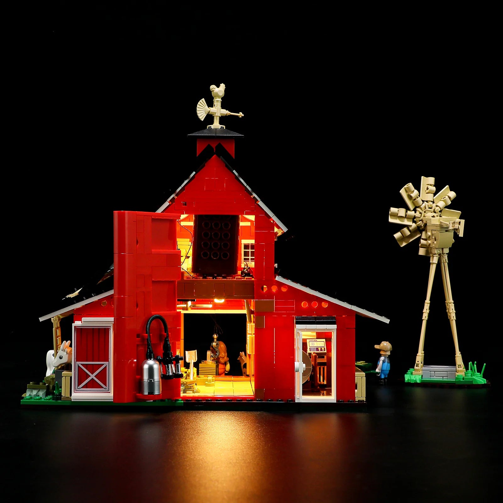 Lumibricks F9037 Cow Barn rear view at night with open barn doors, glowing interior, milking equipment, and farmer minifigure