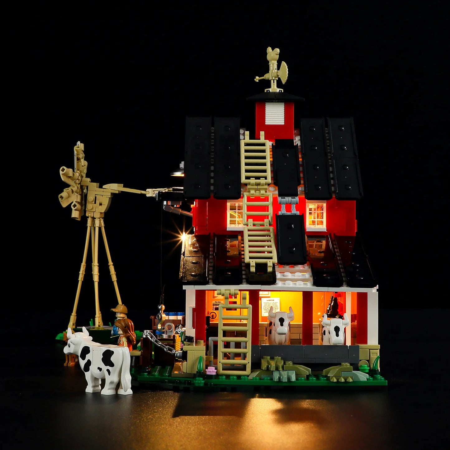 Lumibricks F9037 Cow Barn side angle at night with open roof panels, illuminated stalls, cows inside, and windmill detail