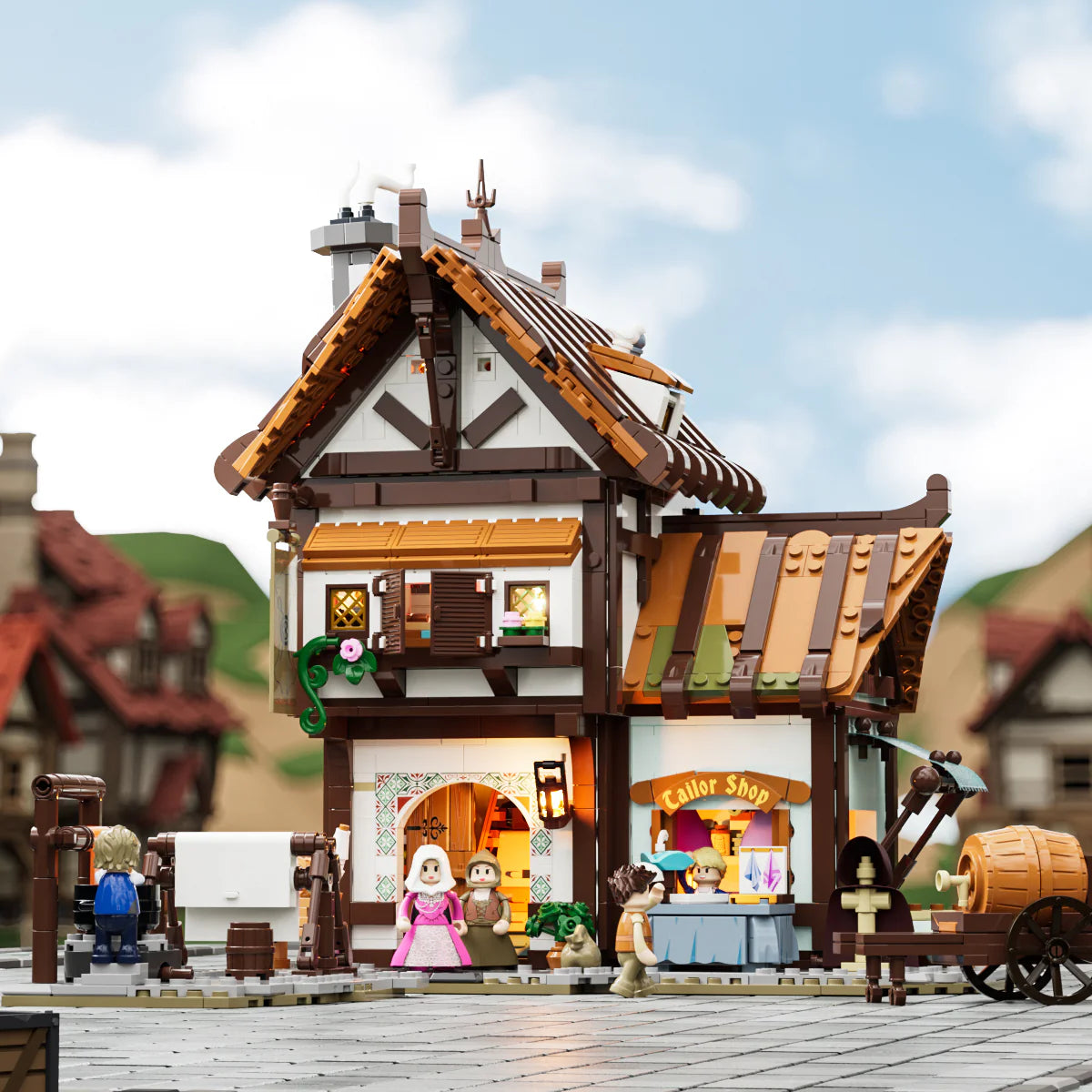 Lumibricks F9038 Medieval Tailor Shop front view in daylight with market stall, tailor minifigures, and wooden cart