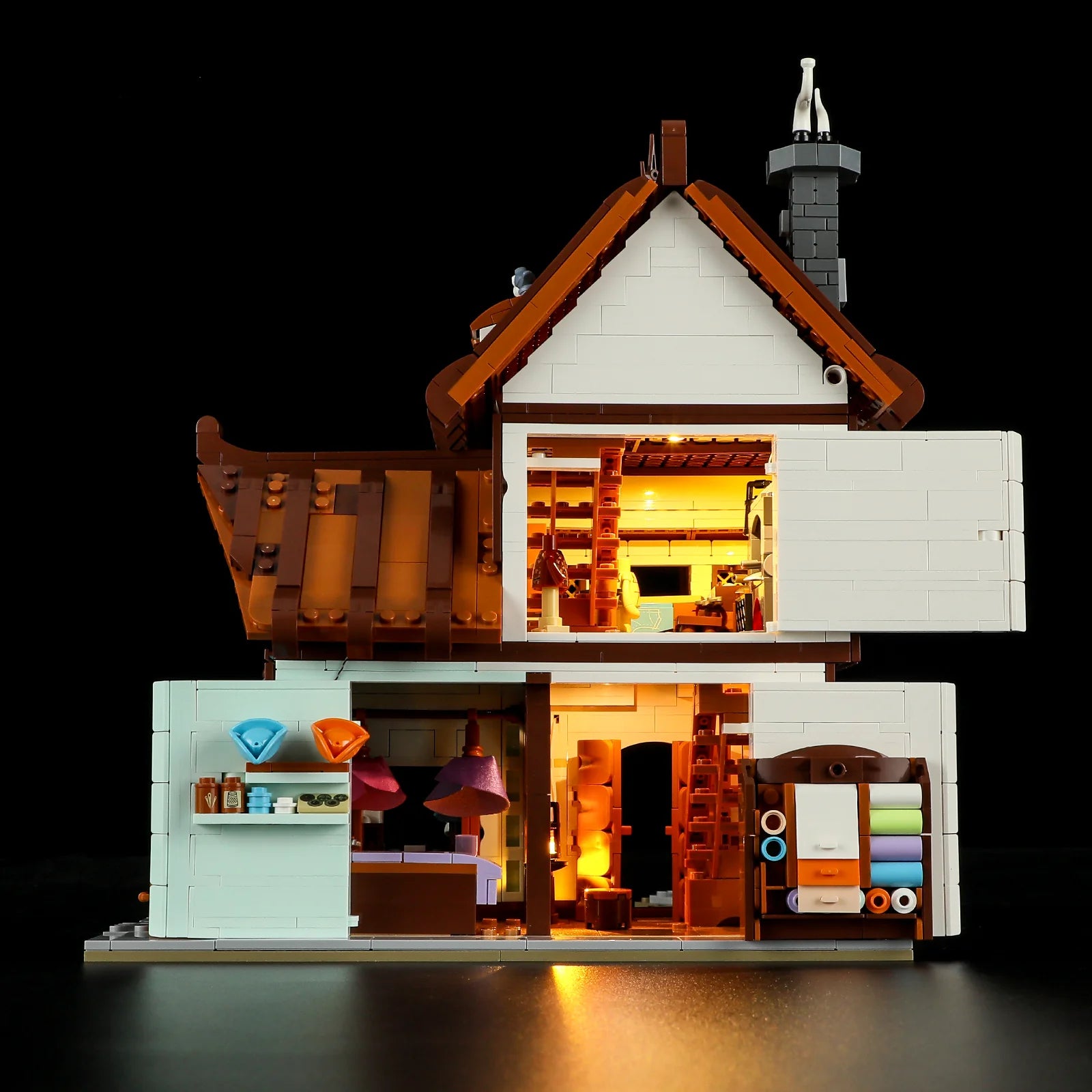Lumibricks F9038 Medieval Tailor Shop interior cross-section showing lit workshop, fabric shelves, and cozy living space